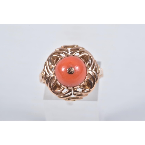 23 - A YELLOW METAL CORAL RING, set with a raised coral cabochon with pin to the centre, in a claw settin... 