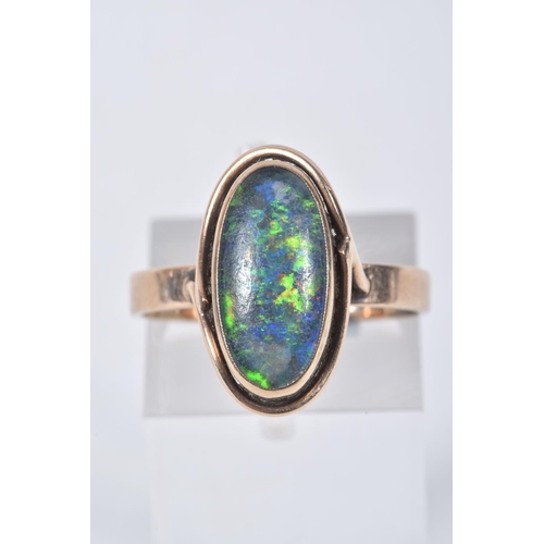 3 - A YELLOW METAL OPAL TRIPLET RING, of an oval design, collet set opal triplet, to a scroll surround a... 