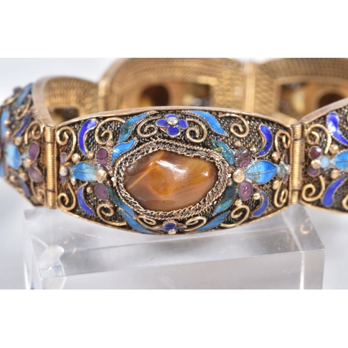 4 - A GEMSET BRACELET, comprised of five domed panels with filigree and enamel detail, each panel set wi... 