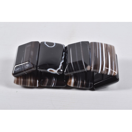 44 - A BANDED AGATE BRACELET, eight panels of carved banded agate, on a stretch bracelet, approximate gro... 