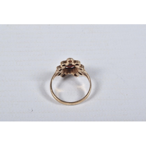 46 - A 9CT GOLD GARNET CLUSTER RING, designed as a central pear shape garnet within a circular cut garnet... 