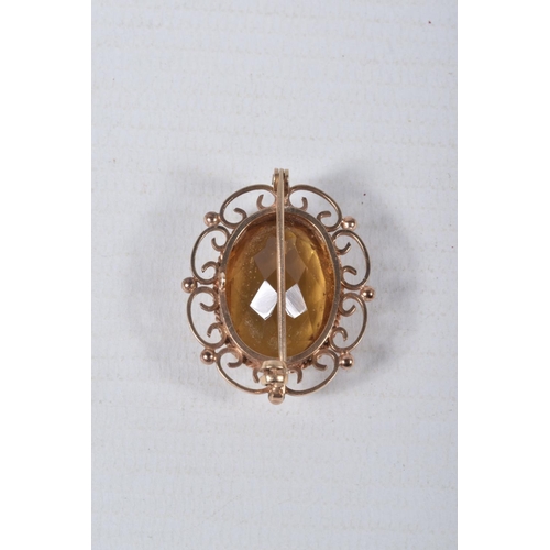 55 - A 9CT GOLD CITRINE BROOCH, of an oval form, set with a large oval cut citrine, in a milgrain collet ... 