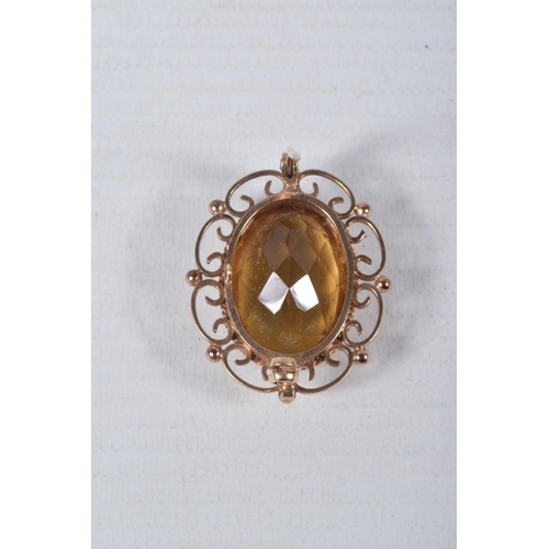 55 - A 9CT GOLD CITRINE BROOCH, of an oval form, set with a large oval cut citrine, in a milgrain collet ... 