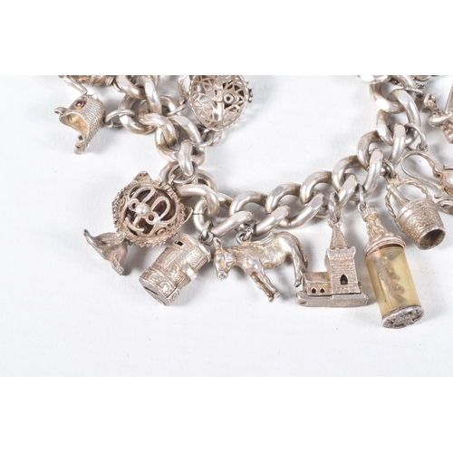 58 - A SILVER CHARM BRACELET, a heavy curb link bracelet fitted with a heart padlock clasp, hallmarked 'J... 