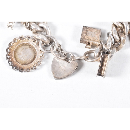 58 - A SILVER CHARM BRACELET, a heavy curb link bracelet fitted with a heart padlock clasp, hallmarked 'J... 