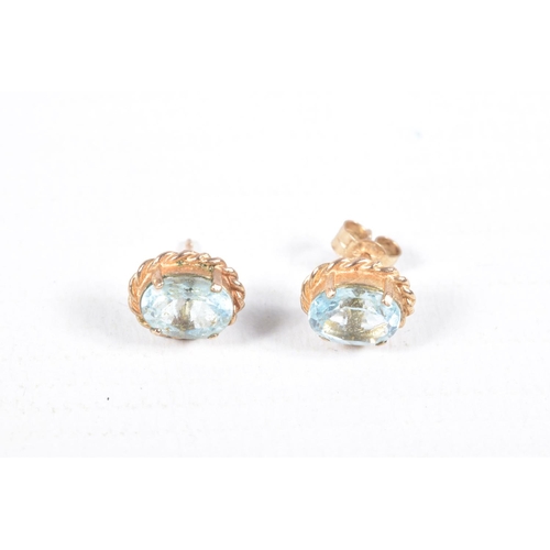 65 - TWO PAIRS OF EARRINGS, to include a pair of oval topaz stud earrings with rope twist surround, and a... 