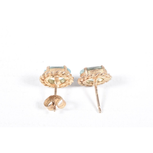 65 - TWO PAIRS OF EARRINGS, to include a pair of oval topaz stud earrings with rope twist surround, and a... 