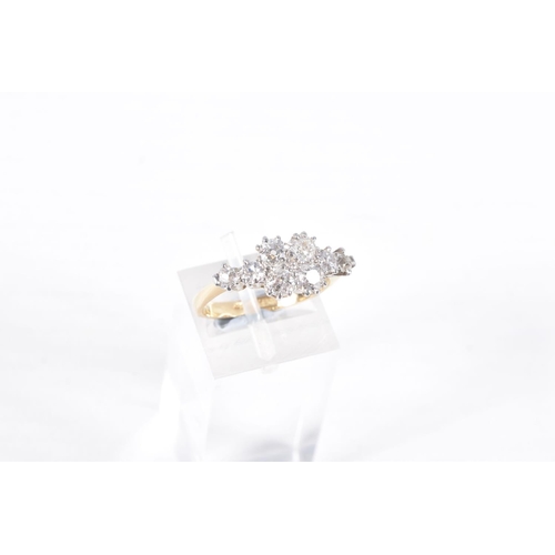 76 - A YELLOW METAL DIAMOND CLUSTER RING, eight old cut diamonds prong set in white metal, approximate to... 