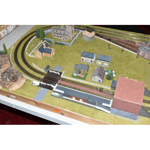 387 - A TABLE TOP N GAUGE MODEL RAILWAY LAYOUT, hardboard base mounted on timber battens, oval double trac... 