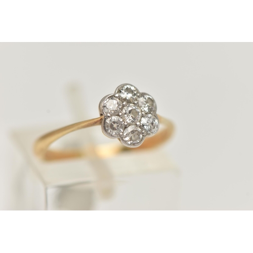 15 - A YELLOW METAL DIAMOND CLUSTER RING, flower shape cluster set with seven old cut diamonds, estimated... 