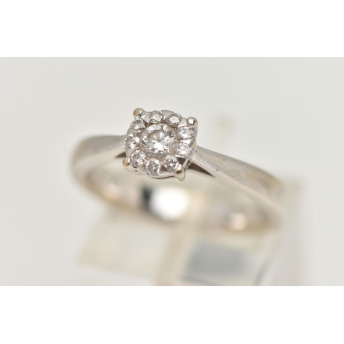 2 - A WHITE METAL DIAMOND CLUSTER RING, centrally set with a round brilliant cut diamond, in a surround ... 