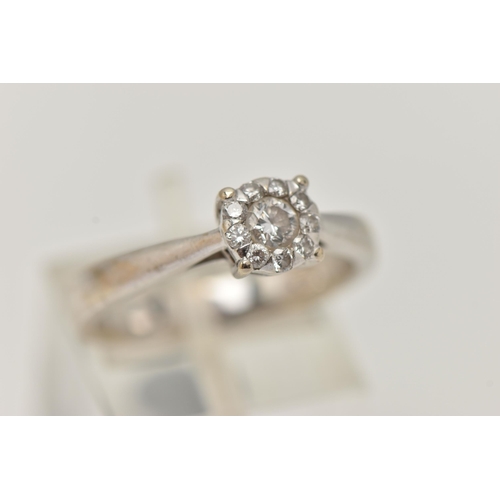 2 - A WHITE METAL DIAMOND CLUSTER RING, centrally set with a round brilliant cut diamond, in a surround ... 