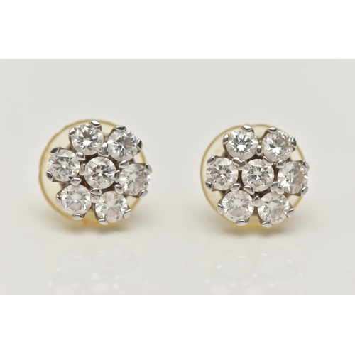 3 - A PAIR OF WHITE METAL DIAMOND CLUSTER EARRINGS, each of a flower shape, set with seven round brillia... 