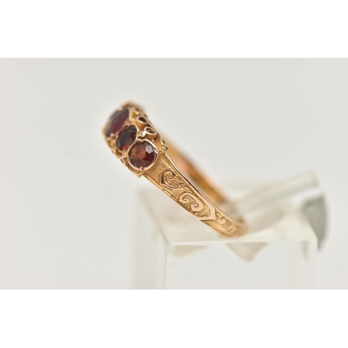 40 - A 15CT GOLD MID VICTORIAN GARNET RING, five circular cut garnets set in yellow gold, scrolling detai... 