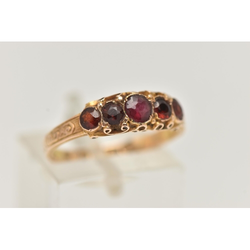 40 - A 15CT GOLD MID VICTORIAN GARNET RING, five circular cut garnets set in yellow gold, scrolling detai... 