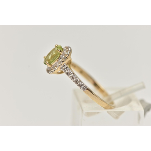 42 - A 9CT GOLD PERIDOT DRESS RING, a principally set oval cut peridot, prong set in yellow gold, set wit... 