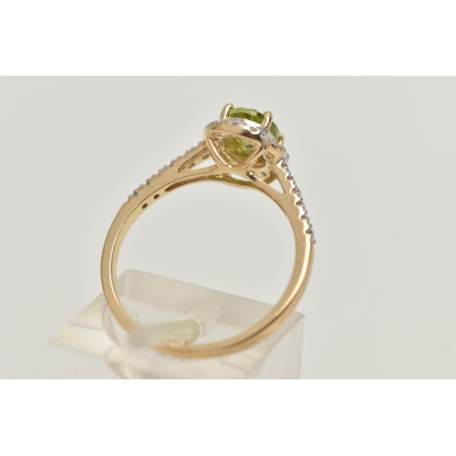 42 - A 9CT GOLD PERIDOT DRESS RING, a principally set oval cut peridot, prong set in yellow gold, set wit... 