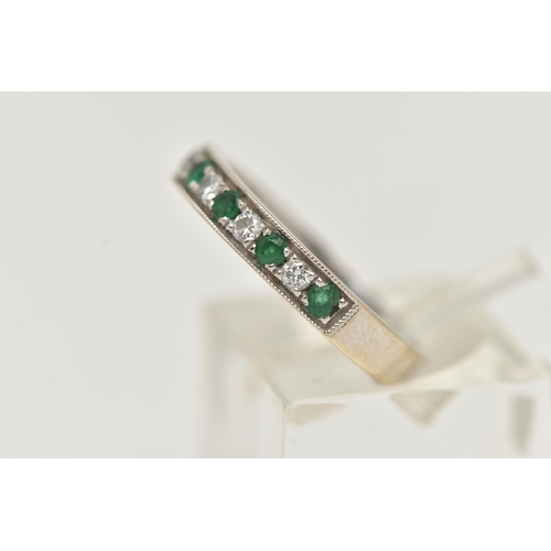 5 - A WHITE METAL EMERALD AND DIAMOND HALF ETERNITY RING, set with seven circular cut emeralds, interspa... 