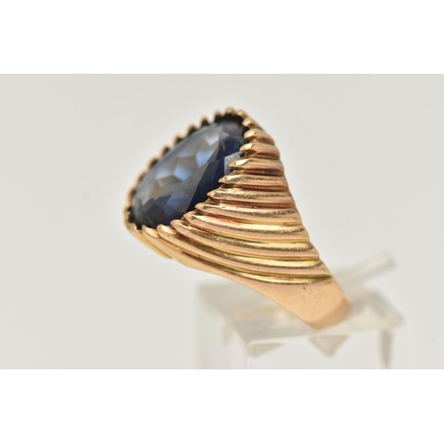 67 - A GEM SET SIGNET RING, designed with an oval sapphire in a tapered ring mount with banded detail, st... 