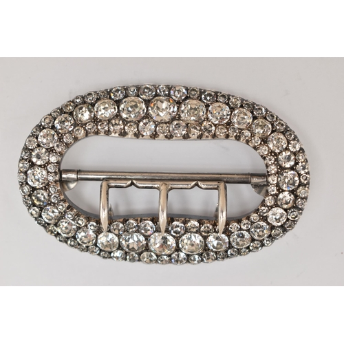 78 - A LARGE WHITE METAL PASTE SET BUCKLE, of an oval form, pave set with colourless paste, measuring app... 