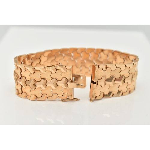 80 - A WIDE ITALIAN BRACELET, designed as articulated geometric links to the push piece clasp with figure... 