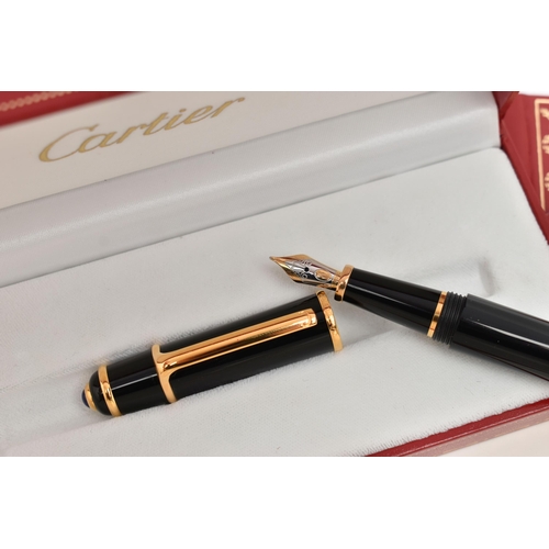 131 - A BOXED 'CARTIER' FOUNTAIN PEN, black resin body with yellow metal collar signed 'Cartier', set with... 