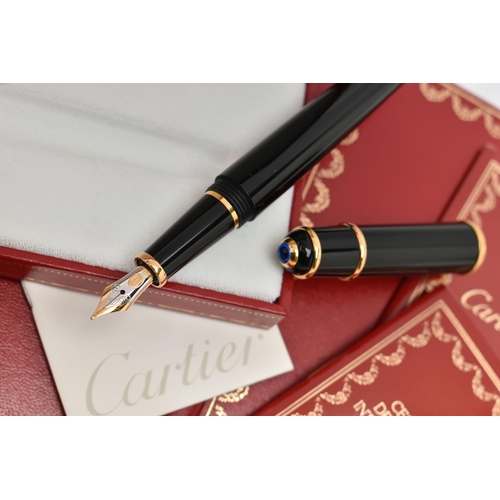 131 - A BOXED 'CARTIER' FOUNTAIN PEN, black resin body with yellow metal collar signed 'Cartier', set with... 