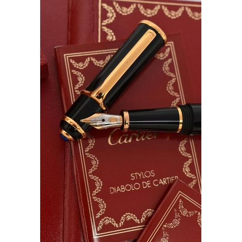 131 - A BOXED 'CARTIER' FOUNTAIN PEN, black resin body with yellow metal collar signed 'Cartier', set with... 