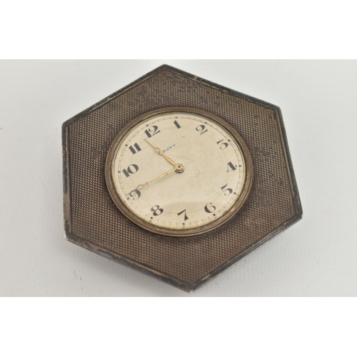 139 - A SILVER 8 DAY BEDSIDE TABLE CLOCK, hexagonal form, engine turned pattern, with a round silvered dia... 