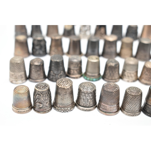 141 - A BAG OF WHITE METAL THIMBLES, various designs and patterns, some set with semi-precious stone termi... 