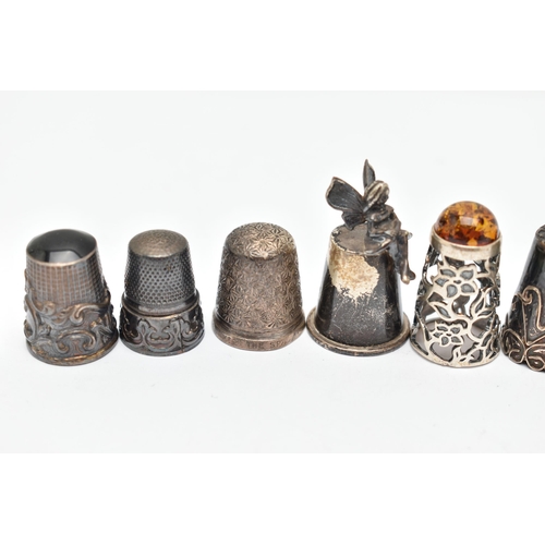 141 - A BAG OF WHITE METAL THIMBLES, various designs and patterns, some set with semi-precious stone termi... 