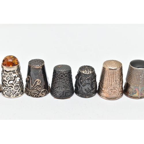 141 - A BAG OF WHITE METAL THIMBLES, various designs and patterns, some set with semi-precious stone termi... 