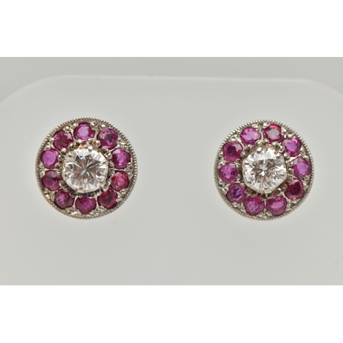 183 - A PAIR OF DIAMOND AND RUBY EARRINGS, designed as a round brilliant cut diamond, set with a surround ... 