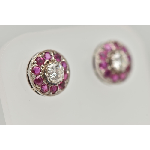 183 - A PAIR OF DIAMOND AND RUBY EARRINGS, designed as a round brilliant cut diamond, set with a surround ... 