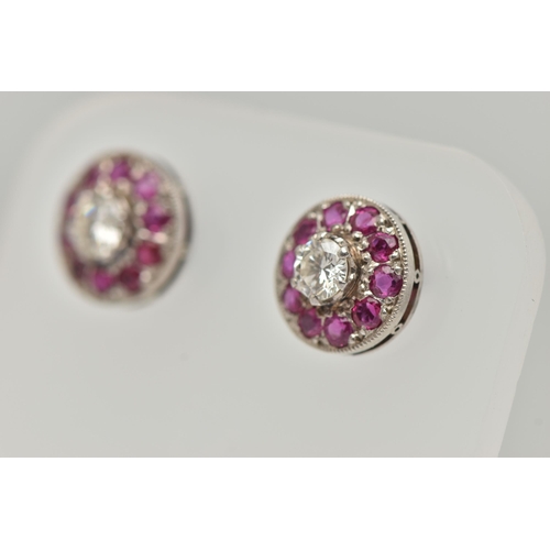 183 - A PAIR OF DIAMOND AND RUBY EARRINGS, designed as a round brilliant cut diamond, set with a surround ... 