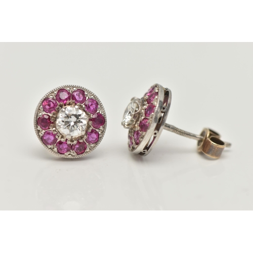 183 - A PAIR OF DIAMOND AND RUBY EARRINGS, designed as a round brilliant cut diamond, set with a surround ... 