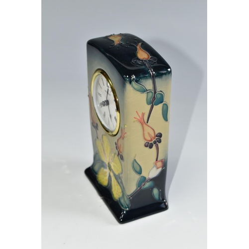 437 - A MOORCROFT POTTERY 'HYPERICUM' PATTERN MANTEL CLOCK, tube lined with yellow and coral pink flowers ... 