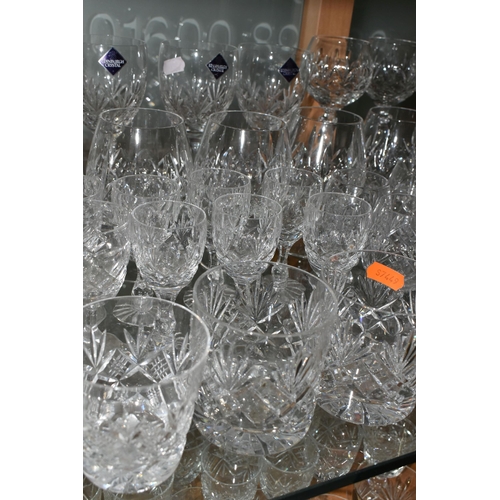A LARGE QUANTITY OF ASSORTED CUT CRYSTAL DRINKING GLASSES, comprising