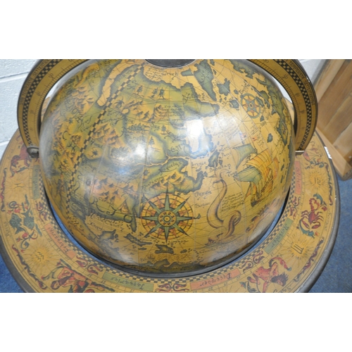 1207 - A 20TH CENTURY DRINKS GLOBE, with a hinged lid, enclosing a fitted interior, raised on spiral suppor... 