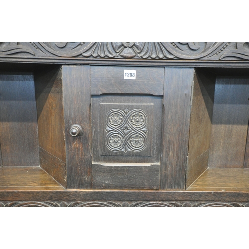 1208 - A LARGE EARLY 20TH CENTURY OAK FIRE SURROUND, with scrolled and foliate carvings, bulbous turned sup... 