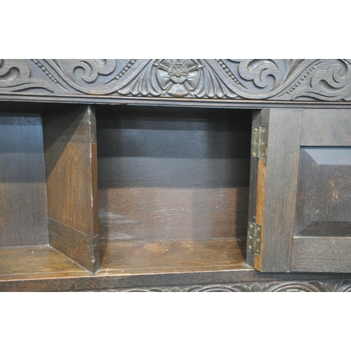 1208 - A LARGE EARLY 20TH CENTURY OAK FIRE SURROUND, with scrolled and foliate carvings, bulbous turned sup... 