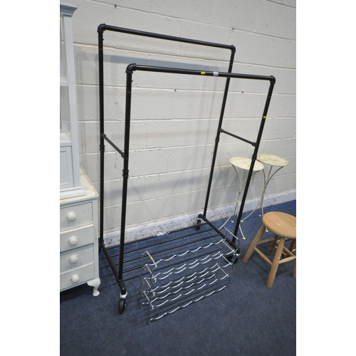 1219 - A BLACK TUBULAR METAL ROLLING RAIL, a pair of metal plant stands, a painted mahogany chest of four d... 