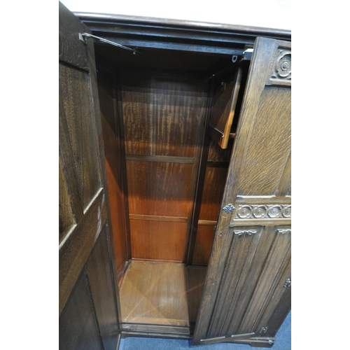 1220 - A 20TH CENTURY OAK TWO PIECE BEDROOM SUITE, comprising a double door wardrobe, with floral and linen... 