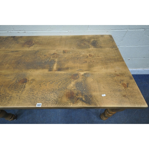 1227 - A 20TH CENTURY PINE RECTANGULAR FARMHOUSE STYLE TABLE, raised on turned legs, width 140cm x depth 88... 