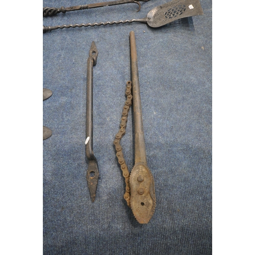 1230 - A PAIR OF VICTORIAN CAST IRON ANTI CLIMB SPIKES, a door handle, a chain pipe wrench, along with four... 