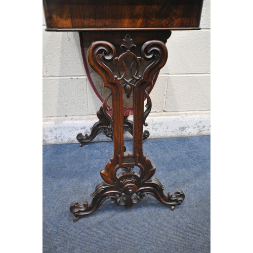 1238 - A VICTORIAN ROSEWOOD WORK TABLE, with a hinged lid, that's enclosing various divisions, raised on sc... 