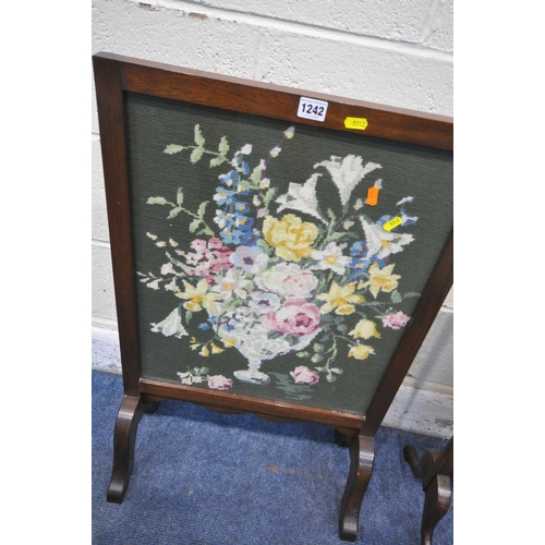 1242 - THREE VARIOUS 20TH CENTURY OAK FIRE SCREENS, all with floral needlework inserts, largest width 50cm ... 