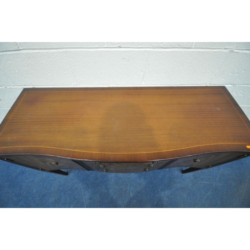 1253 - A REPRODUCTION MAHOGANY SERPENTINE SIDEBOARD, fitted with two cupboard doors, flanking three drawers... 