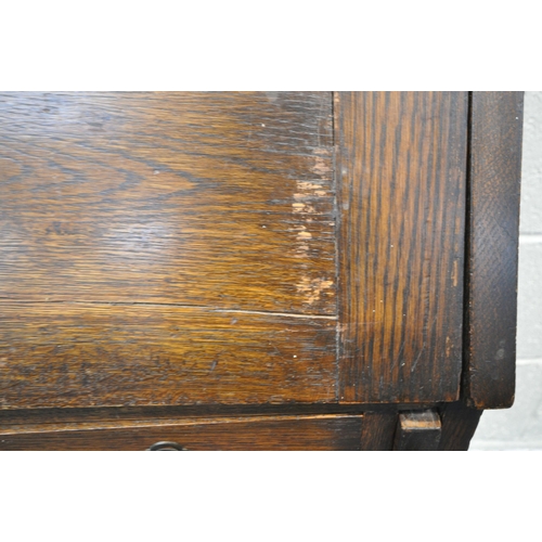 1257 - A 20TH CENTURY OAK STUDENTS BUREAU, the fall front door enclosing a fitted interior, above a single ... 