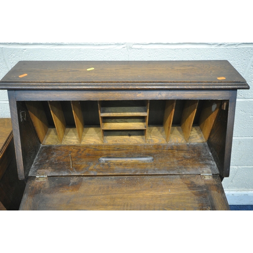 1257 - A 20TH CENTURY OAK STUDENTS BUREAU, the fall front door enclosing a fitted interior, above a single ... 